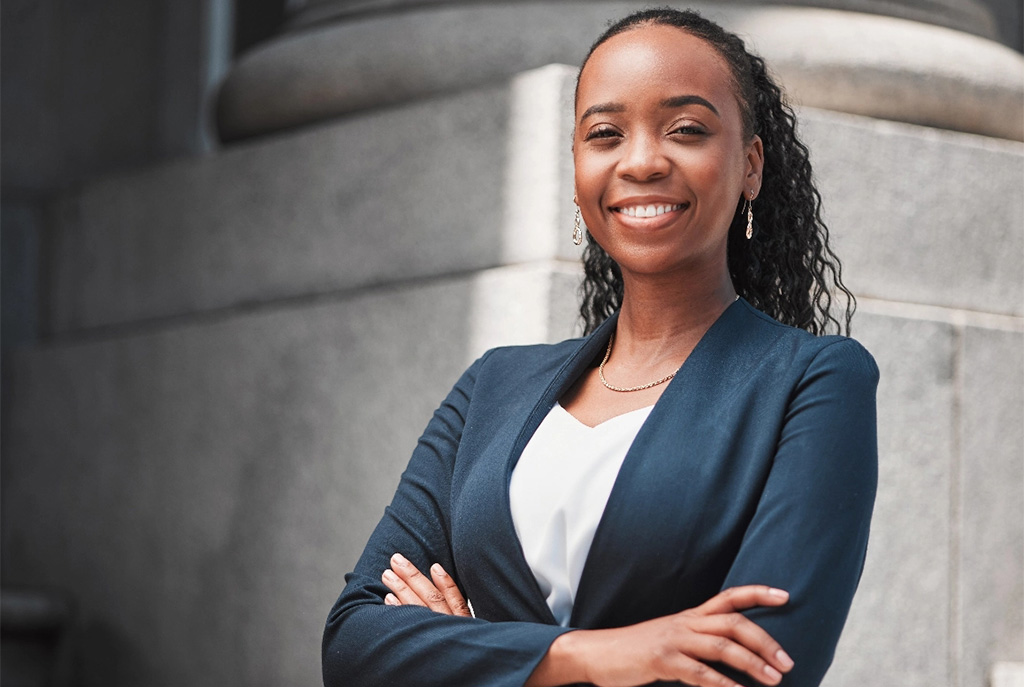 Arms crossed portrait of happy black woman tablet