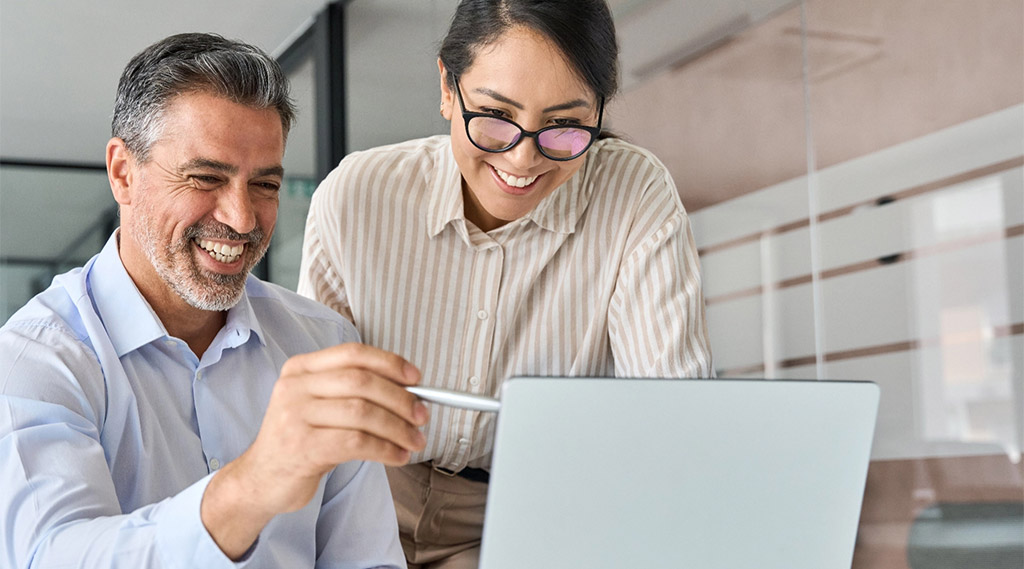 Business professionals looking at laptop tablet