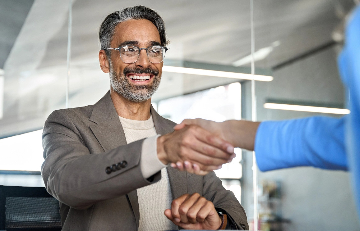 Business professionals shaking hands tablet