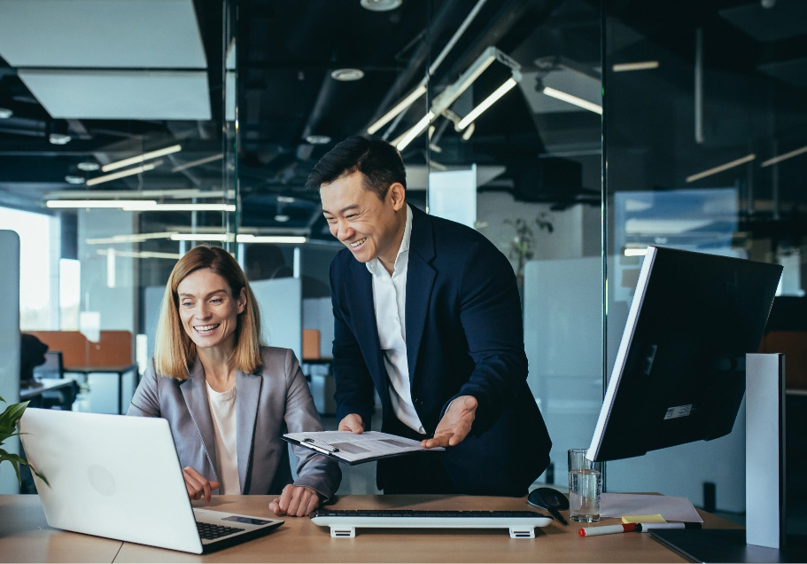 Business professionals smiling working on project