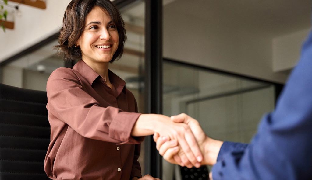Business woman shaking hands with client tablet