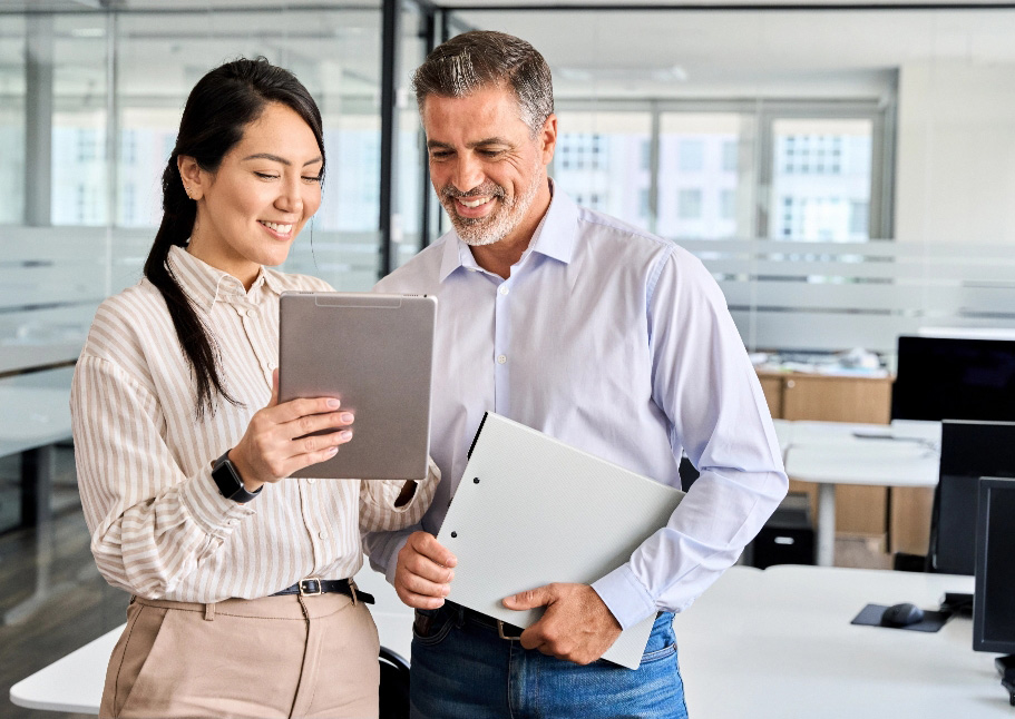 Casual business team man and woman looking at tablet