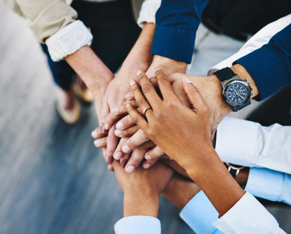 Diverse business team hands in circle