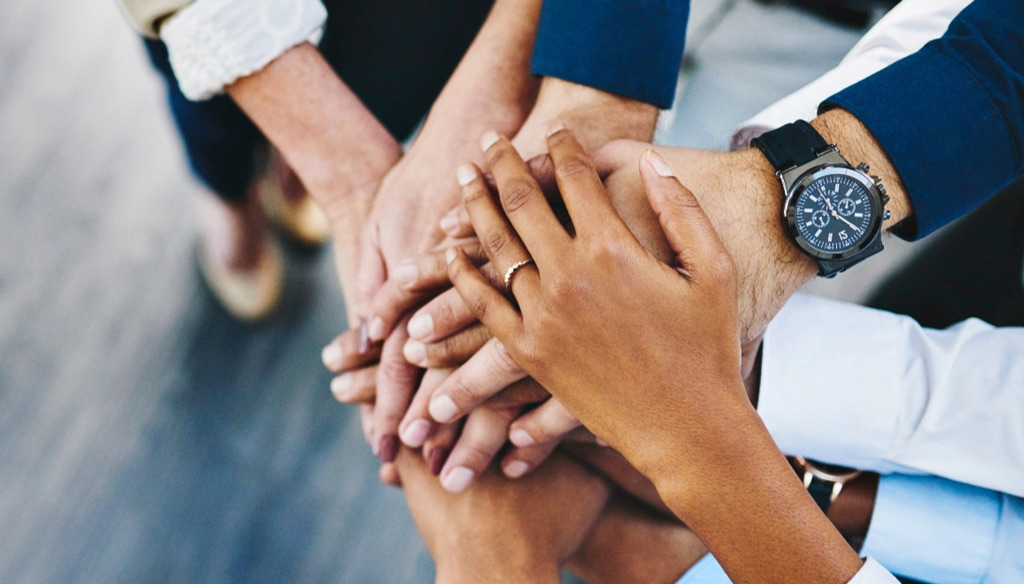 Diverse business team hands in circle tablet
