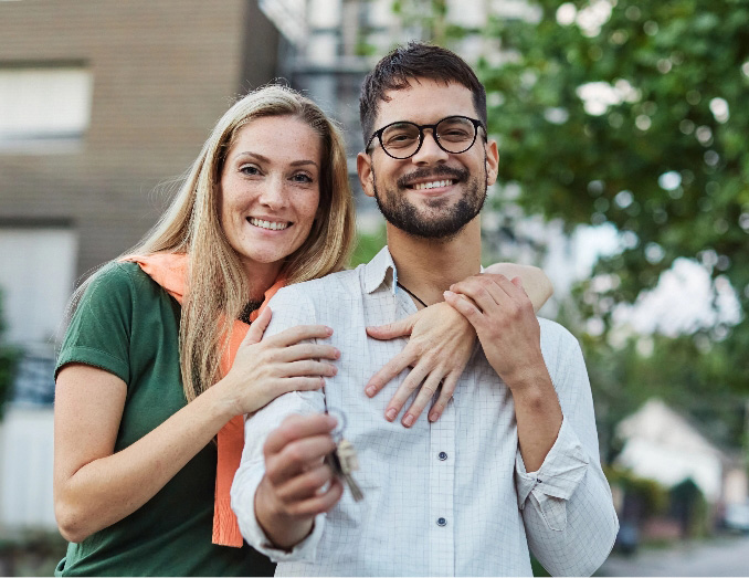 Happy couple holding keys