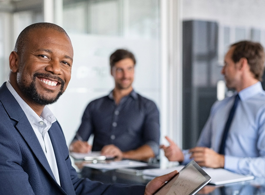 Professional man smiling in boardroom