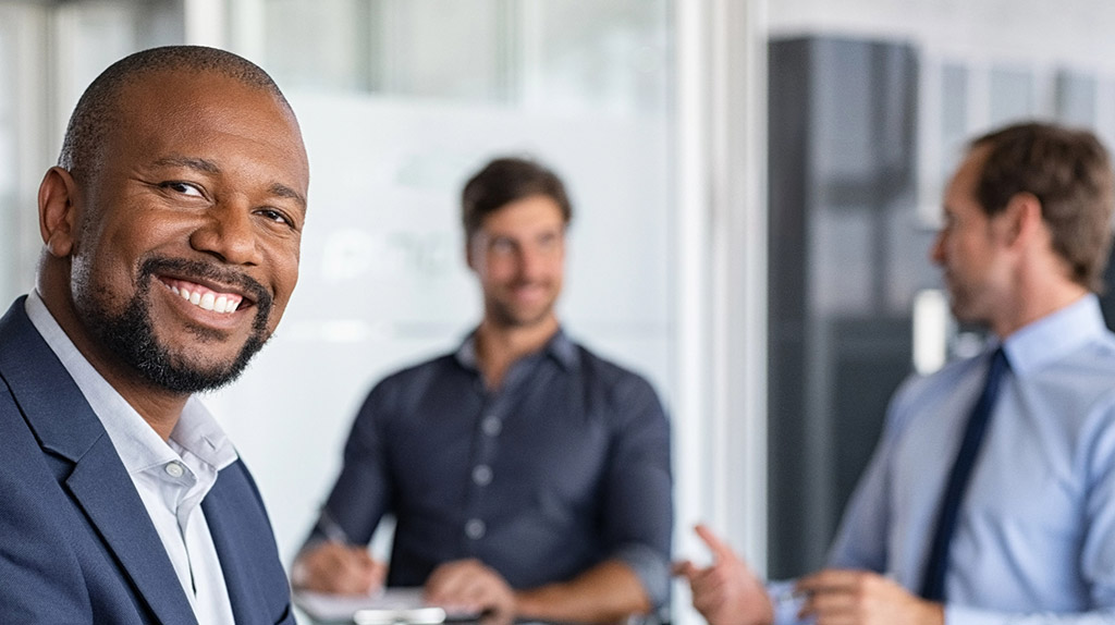 Professional man smiling in boardroom