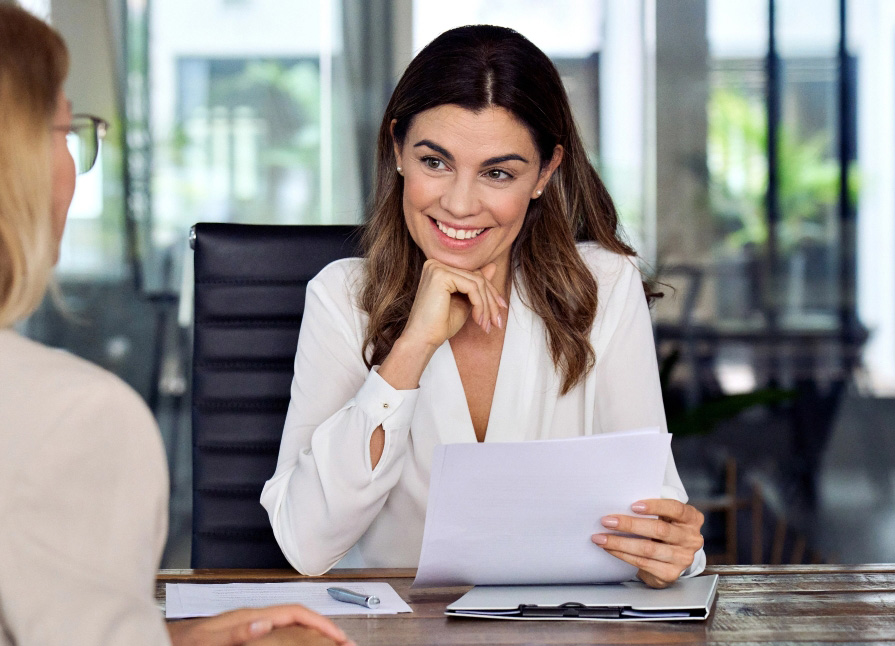 Professional woman smiling with client