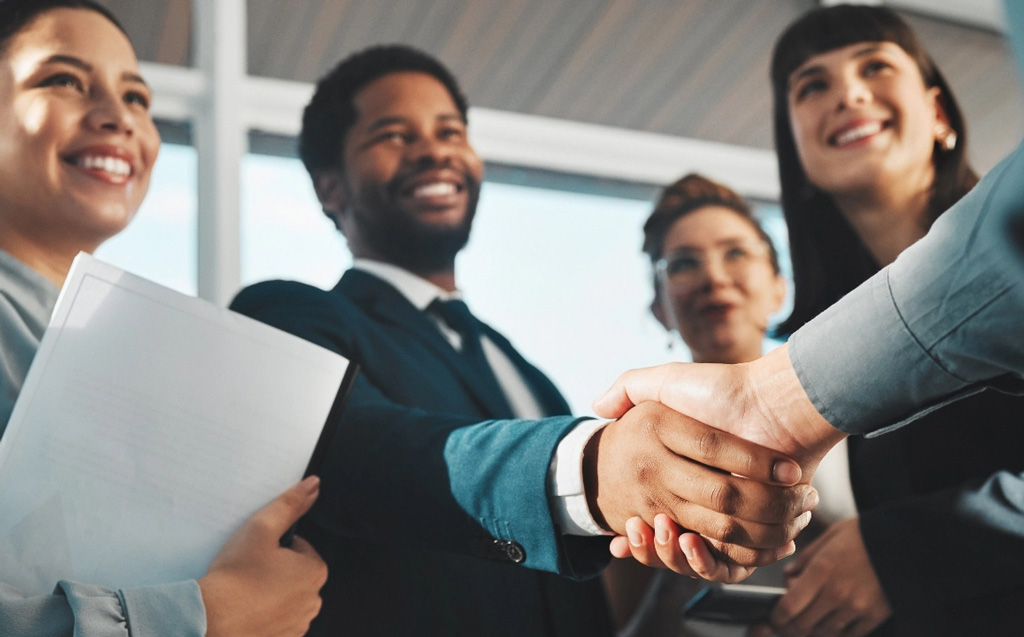 Successful business deal shaking hands tablet
