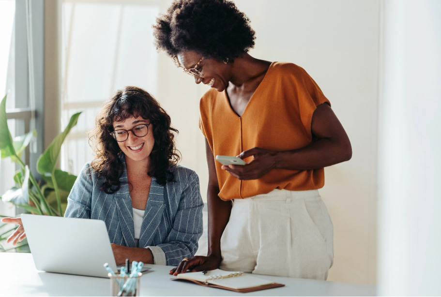 Two business women looking at laptop
