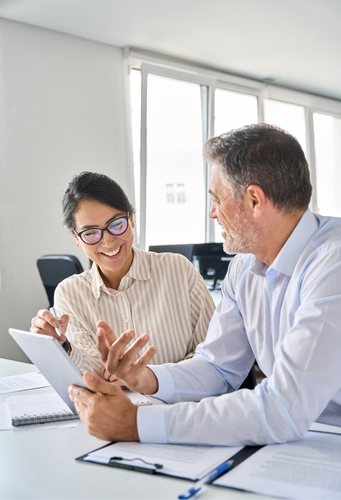 Two person team reviewing project documents