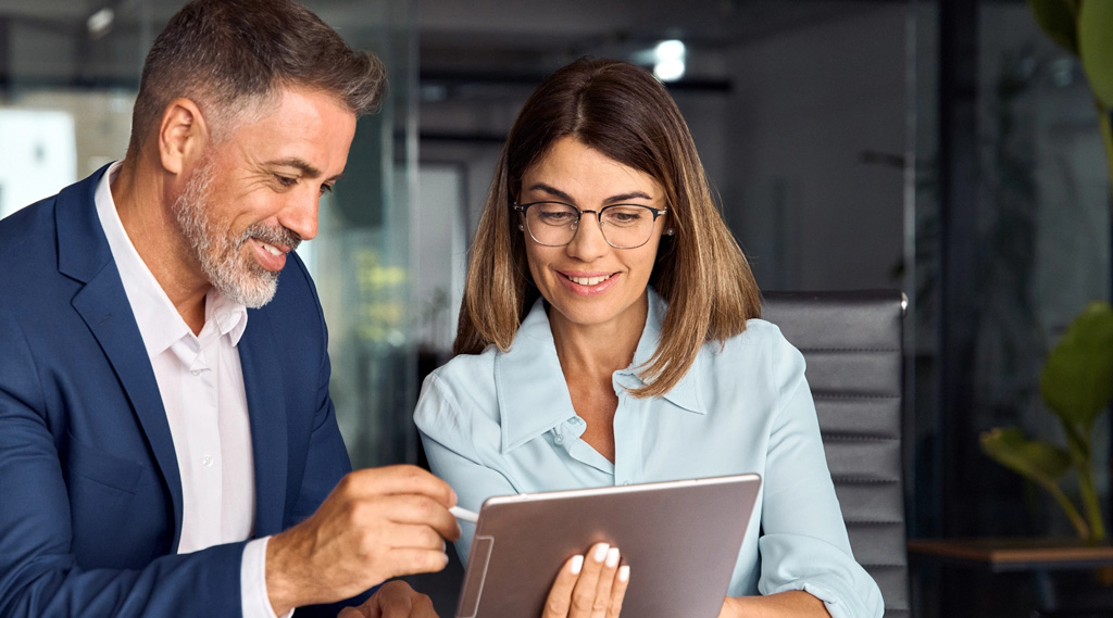 Two professionals looking at tablet mobile