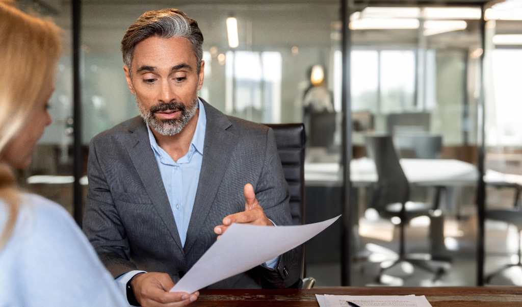 Two professionals review business plans tablet